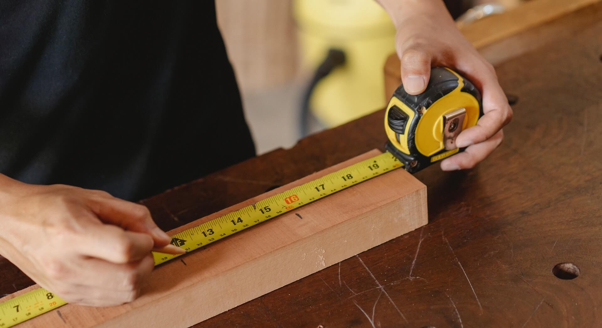 Man using a tape measure. Photo credit Ono Kosuki