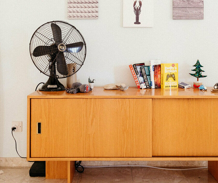 Oscillating fan on a sideboard in a living room. Photo credit: Filios Sazeides