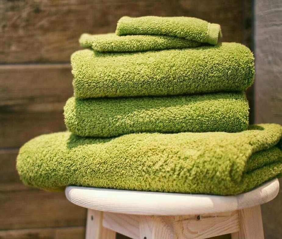Folded towels on a wooden stool. Photo credit: Denny Muller