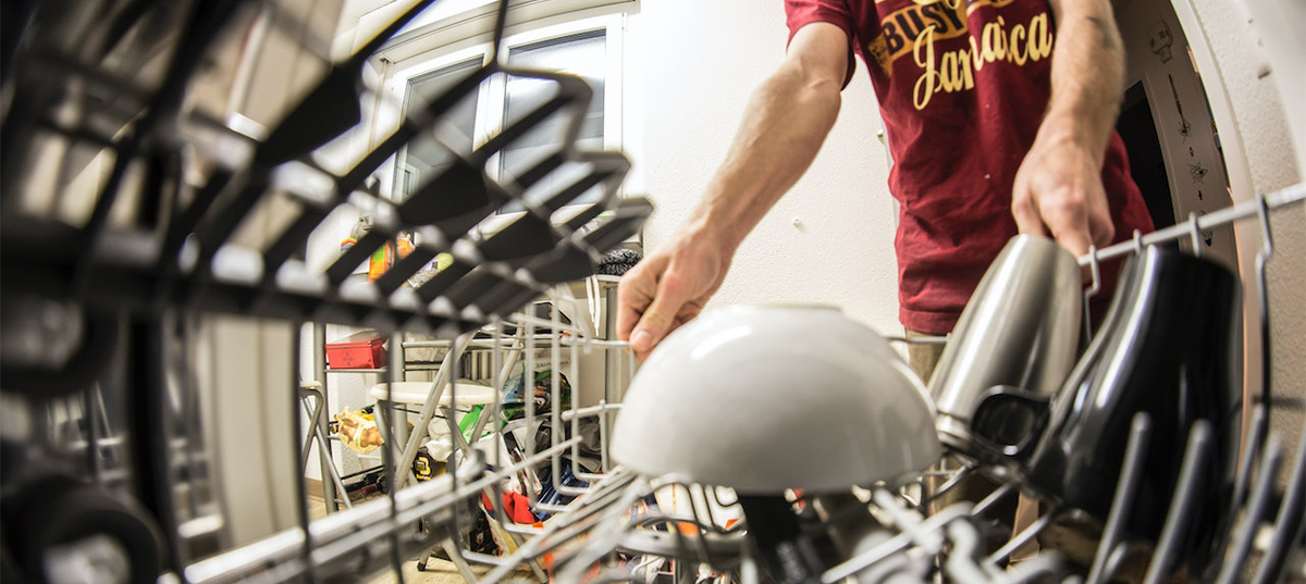 Man loading a dishwasher. Image credit: Wendelin Jacober