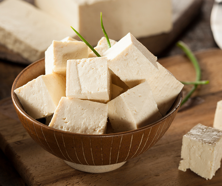 Bowl of cubed tofu on a kitchen counter.