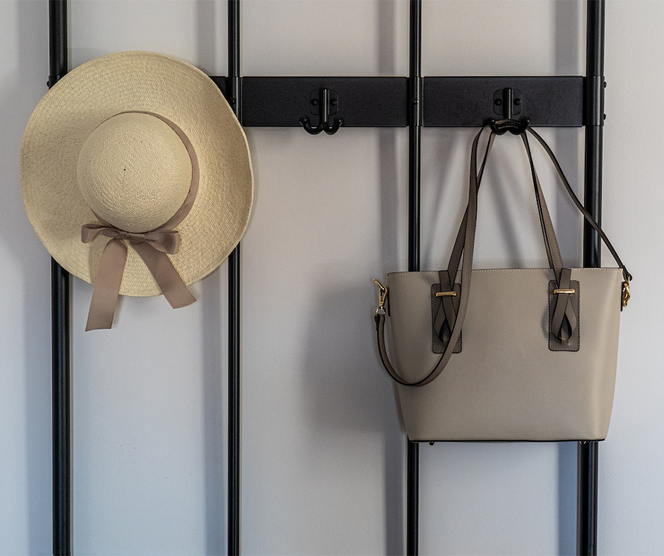 Decorative wall hooks with a hat and purse. Image credit: Castorly Stock