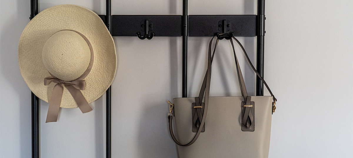 Decorative wall hooks with a hat and purse. Image credit: Castorly Stock