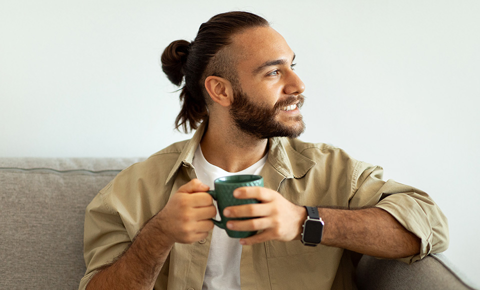 A man sitting drinking coffee