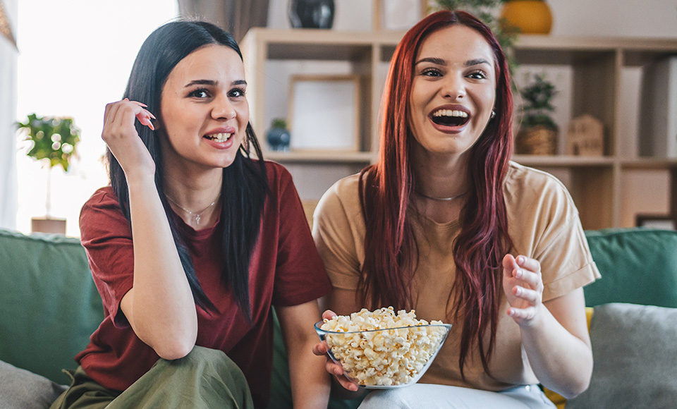 Two women eating popcorn